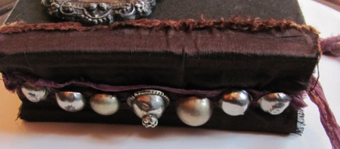 book spine, metal tribal buttons